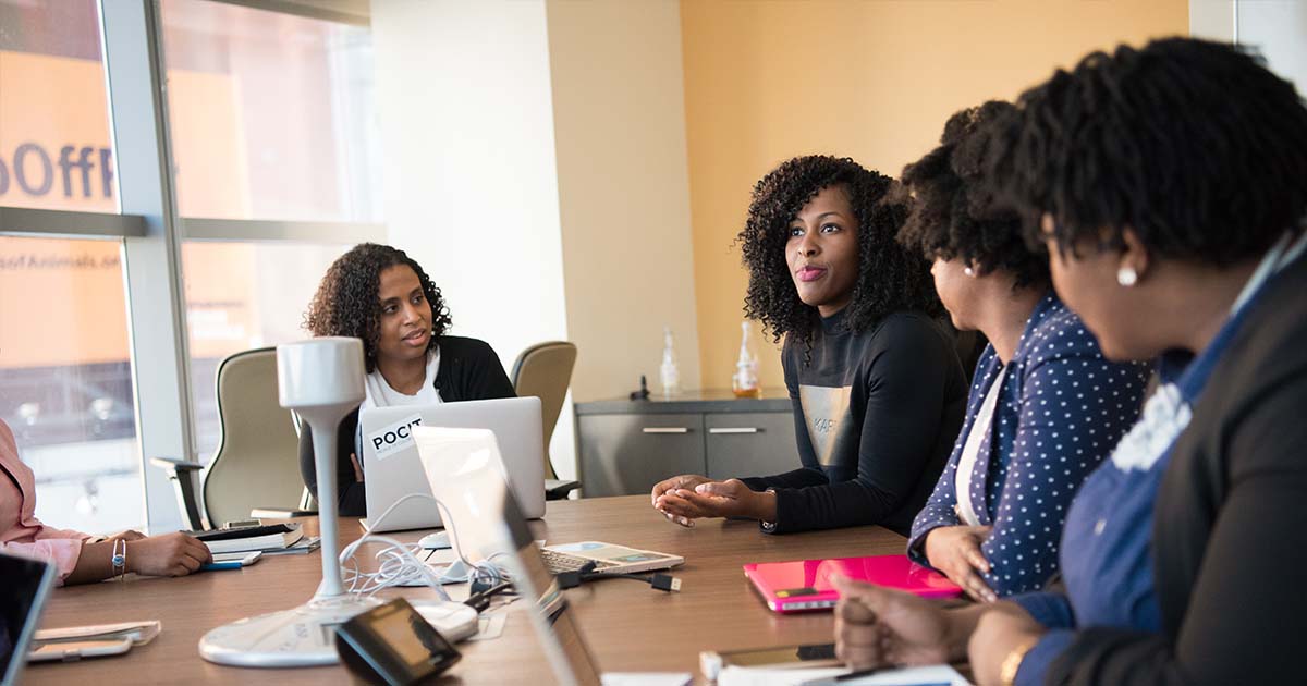 workers talking in a conference room
